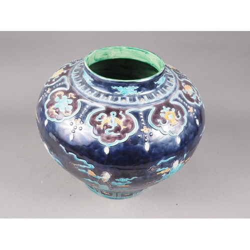 98 - A Chinese early Ming style bulbous vase with figures in clouds decoration on a dark blue ground, 11