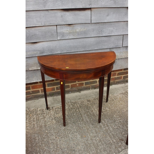 499 - A George III mahogany and banded 'D' shaped fold-over top card table, on square taper supports, 36