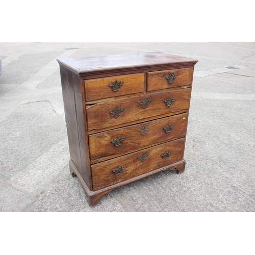 515 - An 18th century fruitwood chest of two short and three long drawers with brass bale handles, on brac... 