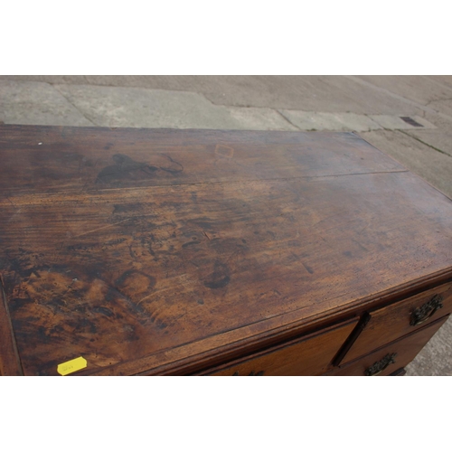 515 - An 18th century fruitwood chest of two short and three long drawers with brass bale handles, on brac... 