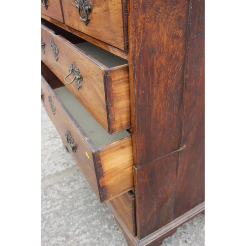 515 - An 18th century fruitwood chest of two short and three long drawers with brass bale handles, on brac... 