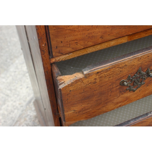 515 - An 18th century fruitwood chest of two short and three long drawers with brass bale handles, on brac... 