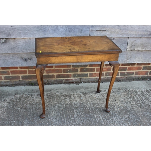 544 - A figured walnut rectangular fold-over top card table, on cabriole supports and pad feet, 30