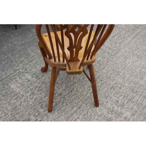 552 - A Stewart Linford yew Windsor standard chair with pierced splat and crinoline stretcher, on turned s... 