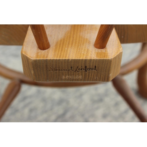 552 - A Stewart Linford yew Windsor standard chair with pierced splat and crinoline stretcher, on turned s... 