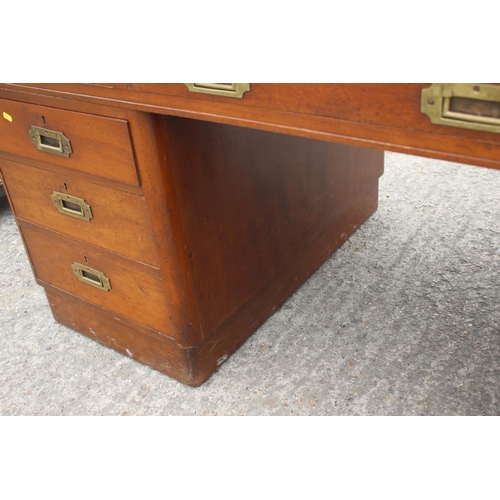 589 - A 1930s walnut double pedestal desk, fitted with military style handles, drawers and blue tooled lea... 