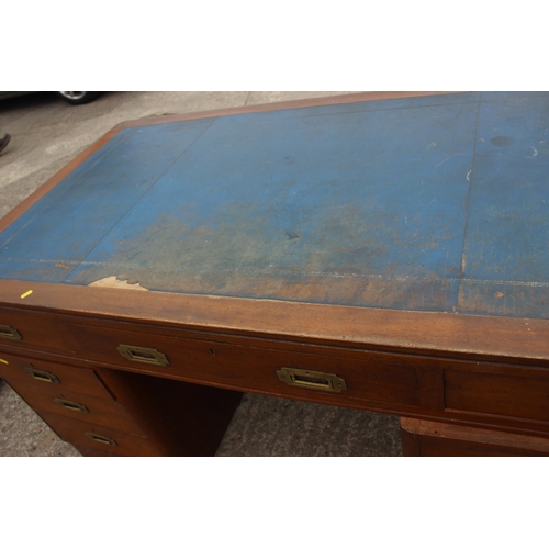 589 - A 1930s walnut double pedestal desk, fitted with military style handles, drawers and blue tooled lea... 