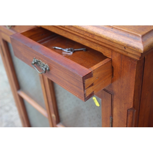 592 - An Edwardian fruitwood, pine and oak side cupboard, fitted two drawers over glazed panel door and on... 