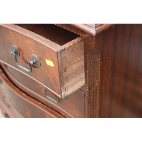 593 - A mahogany and banded serpentine front chest of four long drawers, on bracket feet, 27 1/2