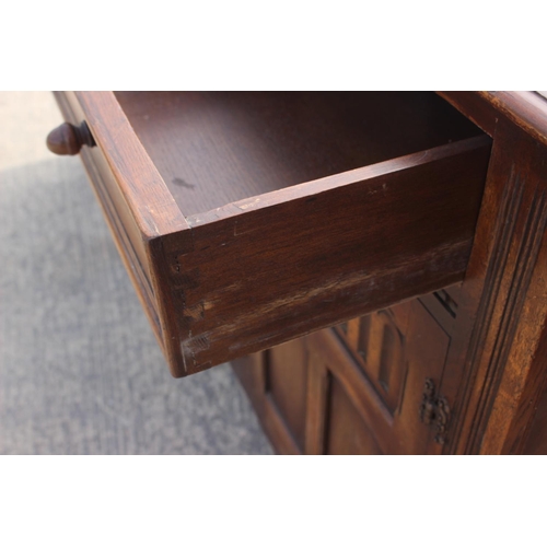 595 - An oak dresser base, fitted three drawers over arcade carved doors, on stile supports, 62