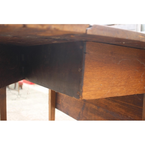 607 - An oak drop leaf dining table, on chamfered supports, 40