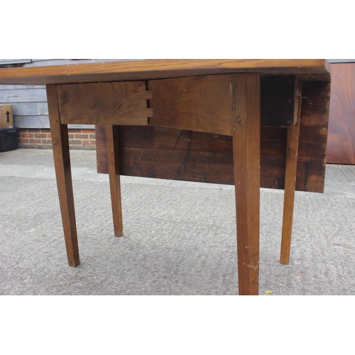 607 - An oak drop leaf dining table, on chamfered supports, 40