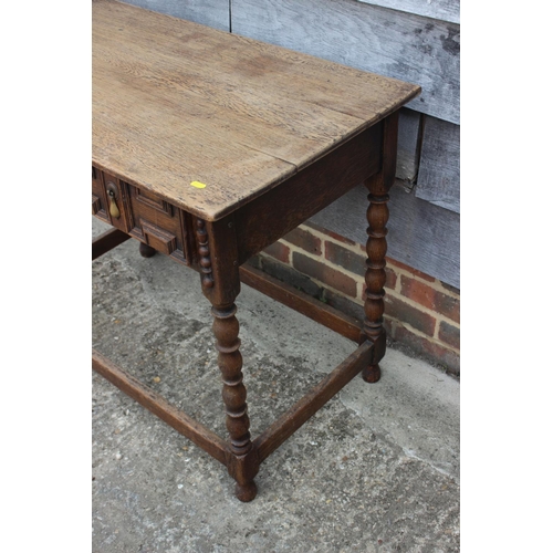 608 - An oak side table of 17th century design, fitted one long drawer, on bobbin turned and stretchered s... 