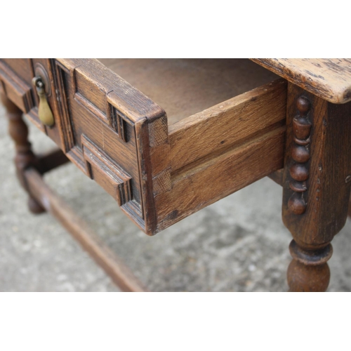 608 - An oak side table of 17th century design, fitted one long drawer, on bobbin turned and stretchered s... 