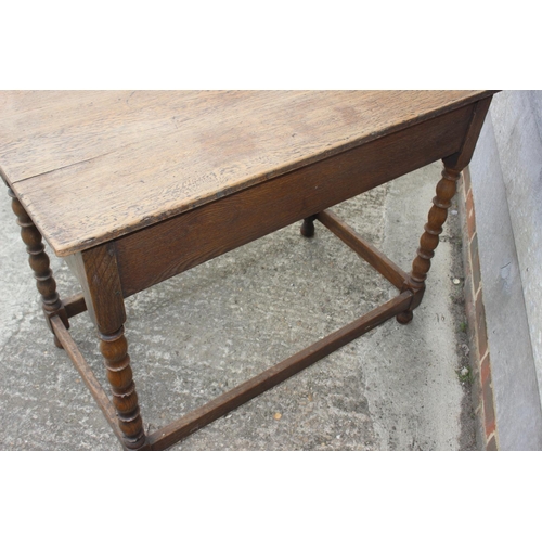 608 - An oak side table of 17th century design, fitted one long drawer, on bobbin turned and stretchered s... 