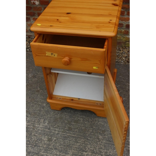 612 - A pine bedside chest of three drawers, on bracket feet, 19