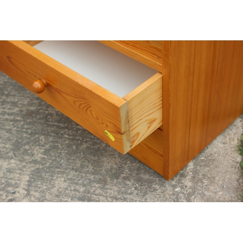 612 - A pine bedside chest of three drawers, on bracket feet, 19