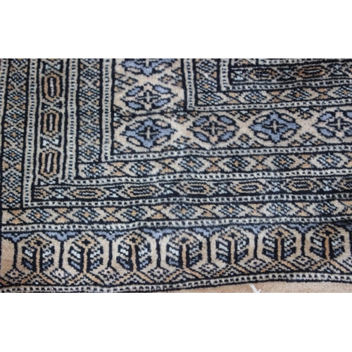 640 - A Middle Eastern rug with central medallion and multi-borders in shades of natural and grey, 59