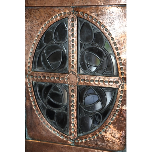 603 - An Arts & Crafts embossed copper covered corner hanging cupboard enclosed oval leaded glazed panel w... 