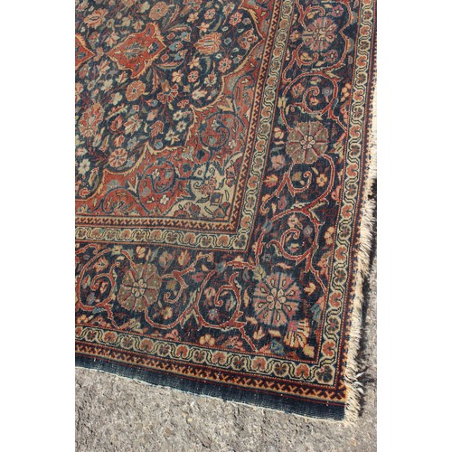 634 - A Kirman rug with all-over floral design on a blue ground, 75