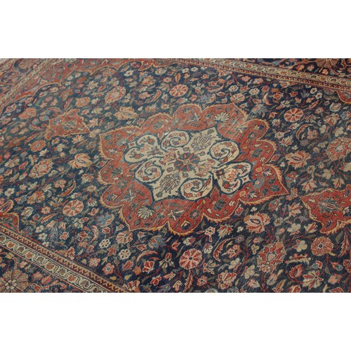 634 - A Kirman rug with all-over floral design on a blue ground, 75