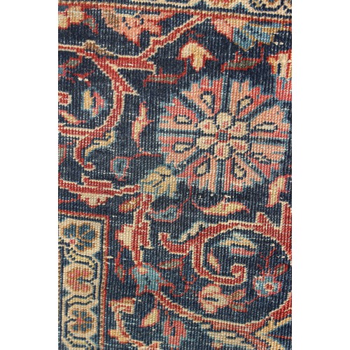 634 - A Kirman rug with all-over floral design on a blue ground, 75