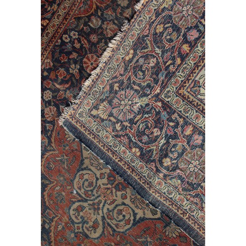 634 - A Kirman rug with all-over floral design on a blue ground, 75