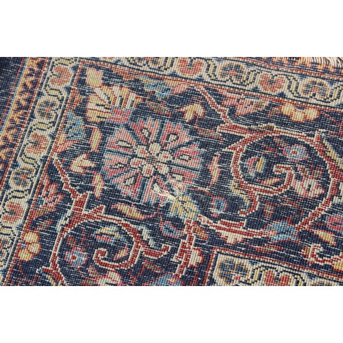 634 - A Kirman rug with all-over floral design on a blue ground, 75