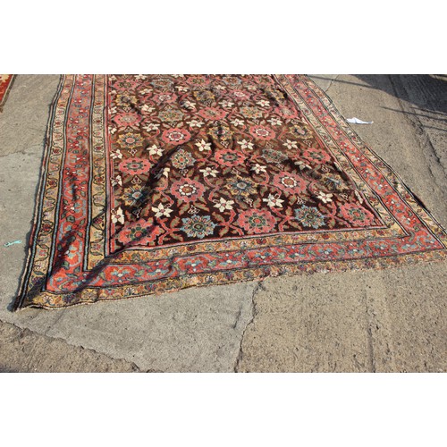 636 - A Hamadan carpet of traditional design with all-over floral design on a dark ground and multi-border... 