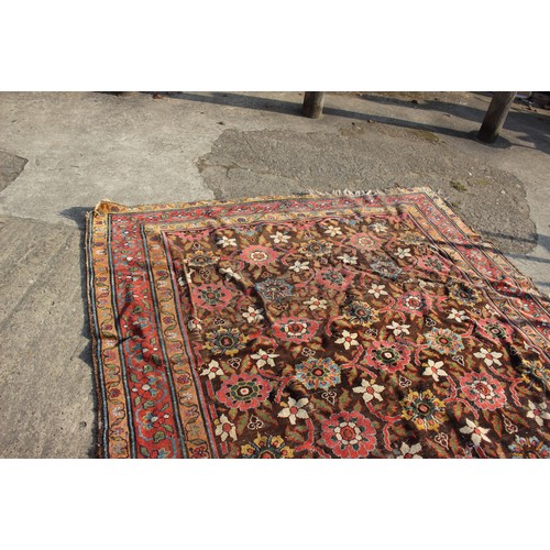 636 - A Hamadan carpet of traditional design with all-over floral design on a dark ground and multi-border... 