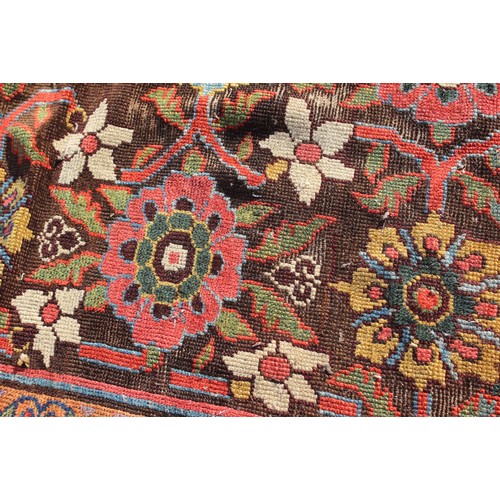 636 - A Hamadan carpet of traditional design with all-over floral design on a dark ground and multi-border... 