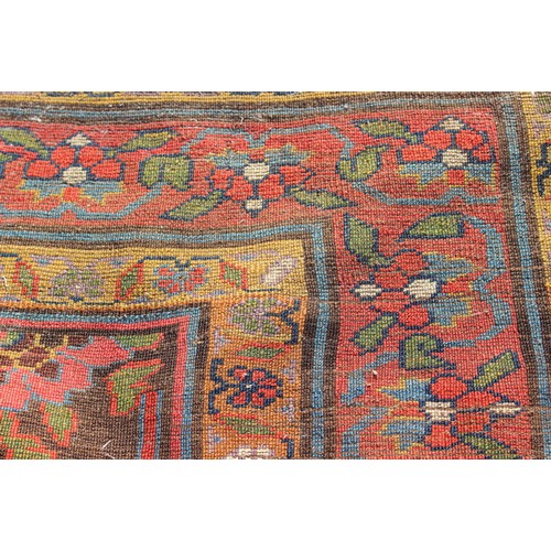 636 - A Hamadan carpet of traditional design with all-over floral design on a dark ground and multi-border... 