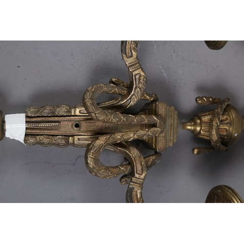 287 - A set of four tooled brass two-light wall brackets of 17th century design, 15