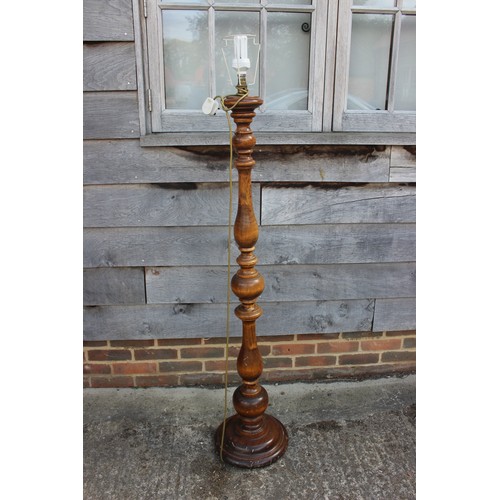 291 - A walnut turned standard lamp, on circular base, 54