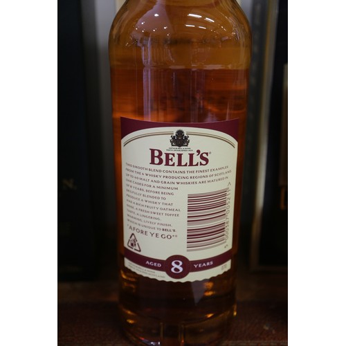 267 - A bottle of Waitrose 12-year old Highland single malt whisky, a bottle of Bells Extra Special Scotch... 