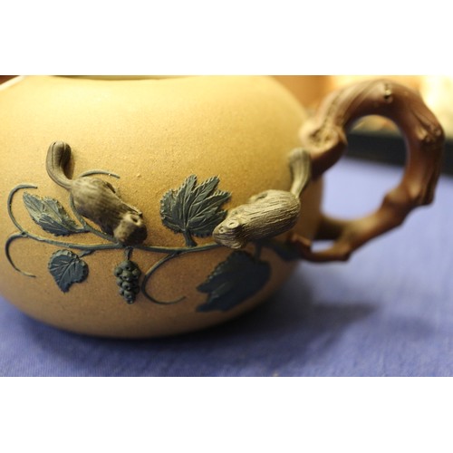 97 - A Chinese Yixing teapot with relief floral decoration, 4 1/4