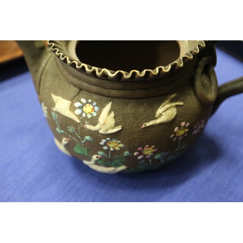 97 - A Chinese Yixing teapot with relief floral decoration, 4 1/4