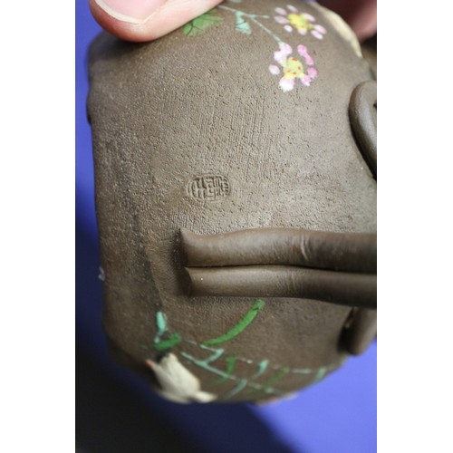 97 - A Chinese Yixing teapot with relief floral decoration, 4 1/4