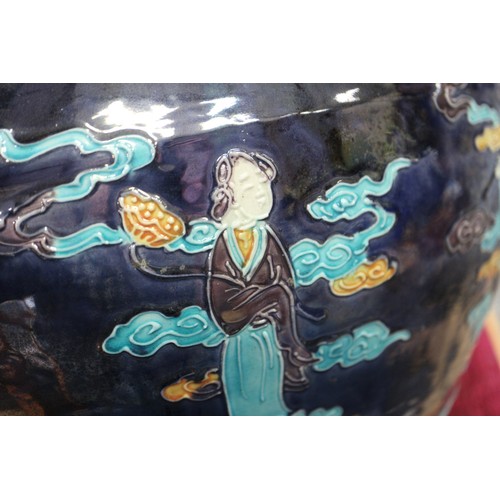 98 - A Chinese early Ming style bulbous vase with figures in clouds decoration on a dark blue ground, 11