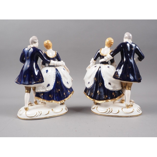 34 - A pair of Japanese porcelain groups, figures in period costume with gilt decoration, 8