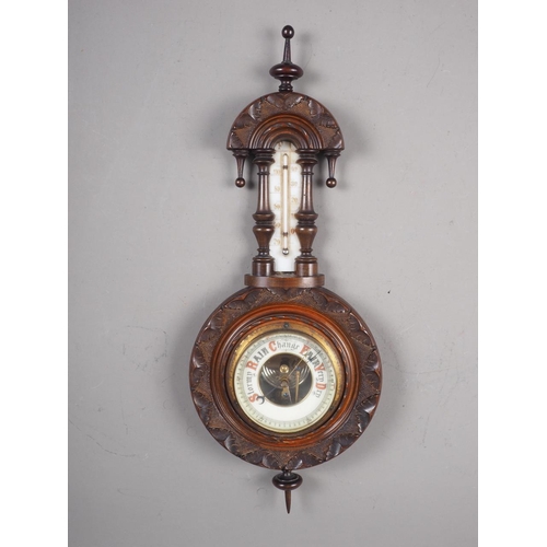 115 - A late 19th century carved and turned mahogany cased aneroid barometer and thermometer, 18