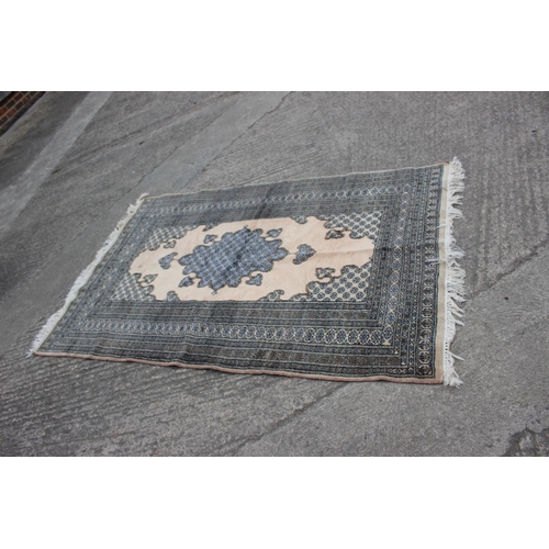 547 - A Middle Eastern rug with central medallion and multi-borders in shades of natural and grey, 59