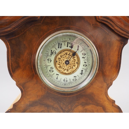 110 - An early 20th century figured walnut shape top mantel clock with gilt dial, 10 3/4