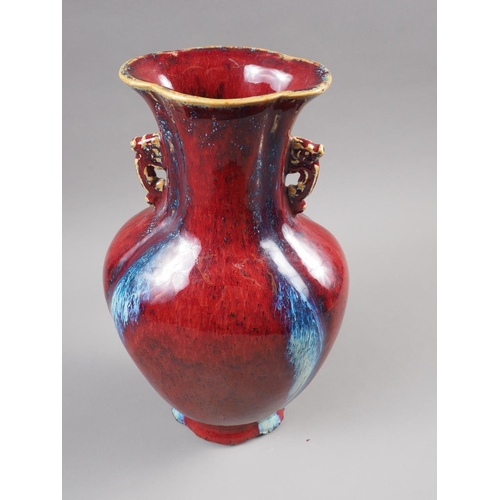 77 - A Chinese flambe two-handled vase with flared rim and four-character mark to base