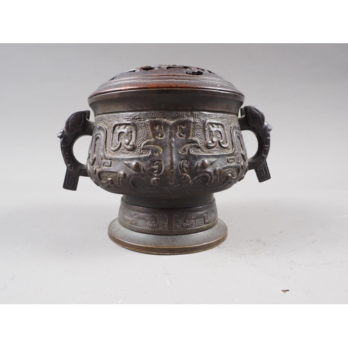 91 - A Chinese brass two-handled censer or archaic design with carved hardwood cover, six-character mark ... 