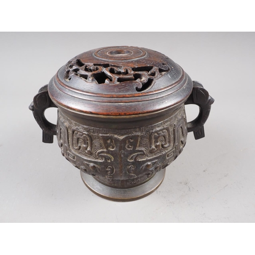 91 - A Chinese brass two-handled censer or archaic design with carved hardwood cover, six-character mark ... 