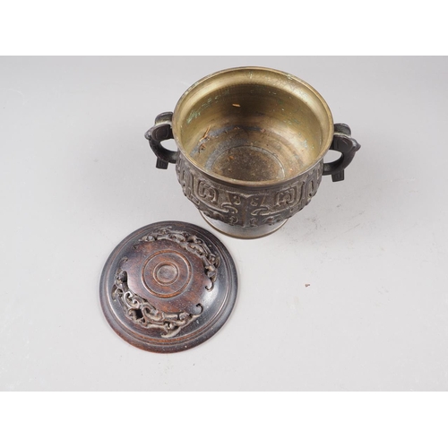 91 - A Chinese brass two-handled censer or archaic design with carved hardwood cover, six-character mark ... 