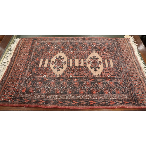 545 - A Bokhara mat with two medallions on a faun ground and multi-borders in traditional shades, 33