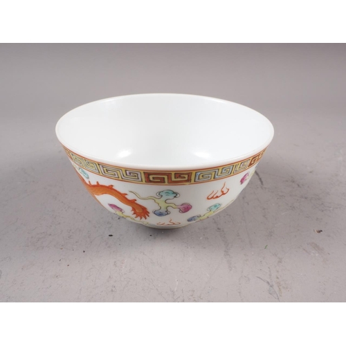 74 - A Chinese porcelain phoenix and dragon decorated bowl with six-character mark, 4 1/2