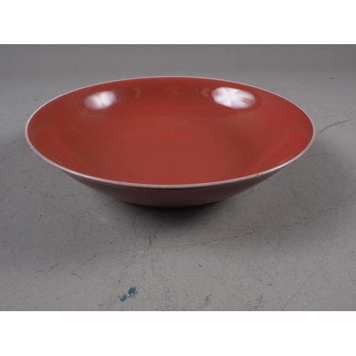 75 - A Chinese porcelain red ground shallow bowl with twelve-character mark, 7 1/2